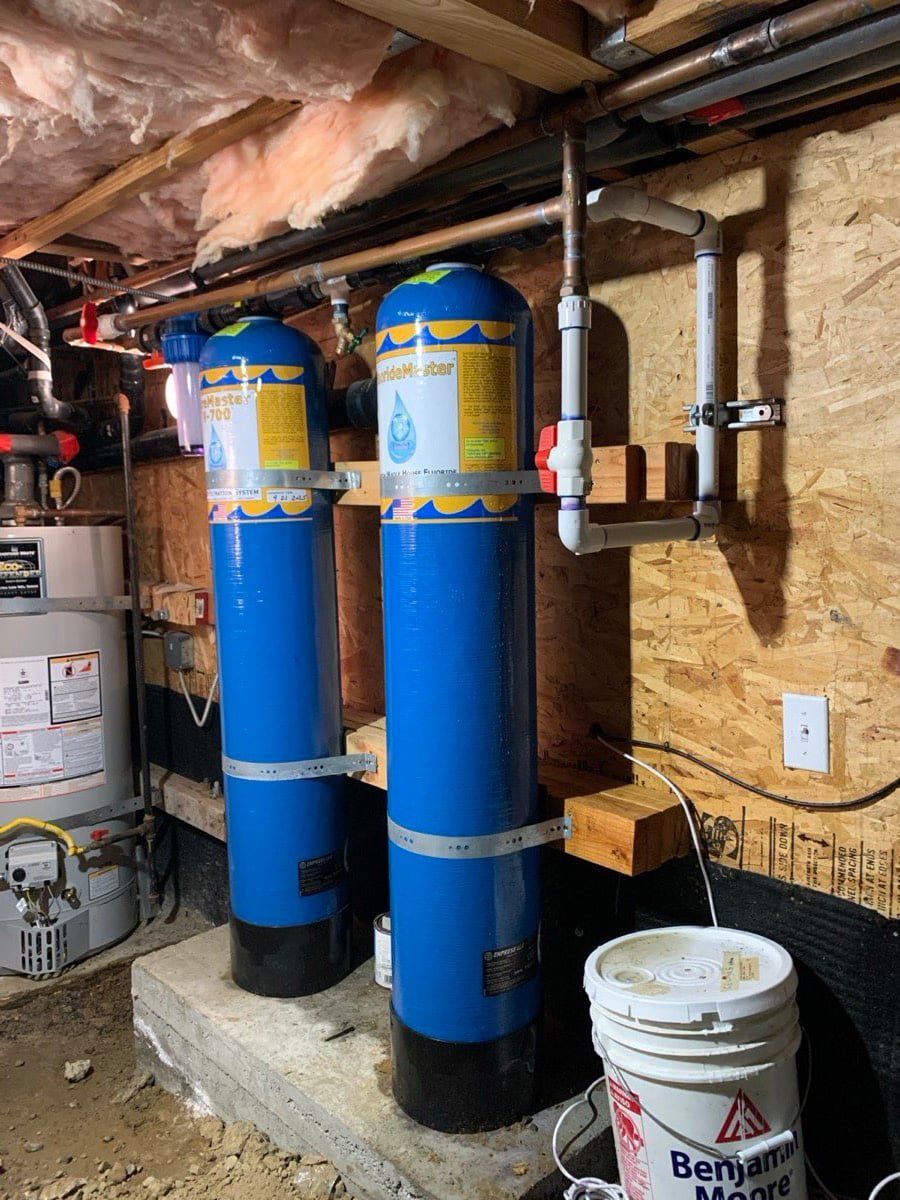Whole-house water filter tanks installed in a crawl space