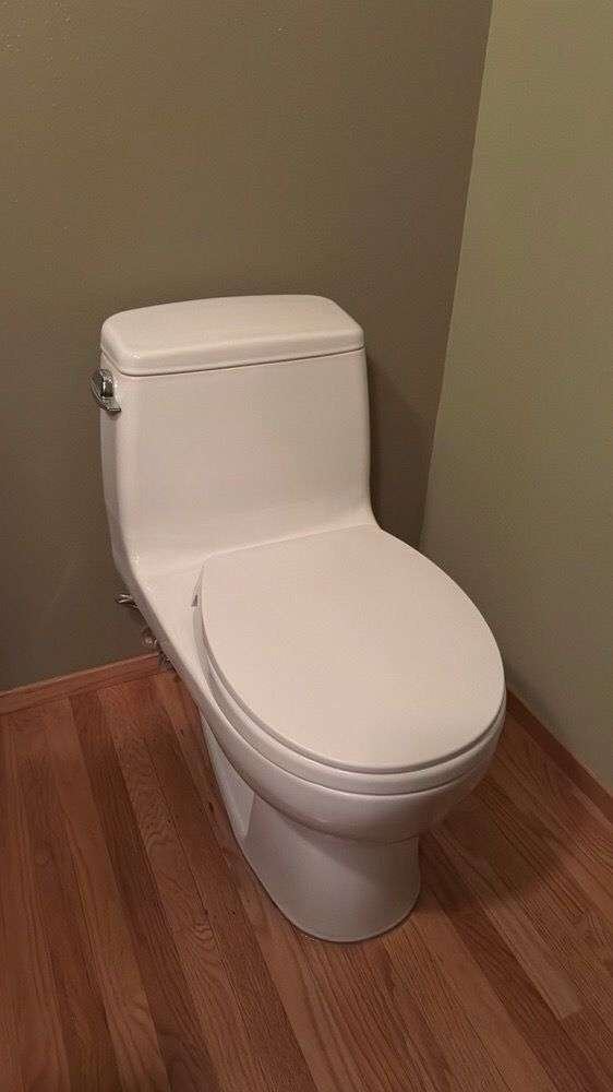 New one-piece toilet installed on a hardwood floor