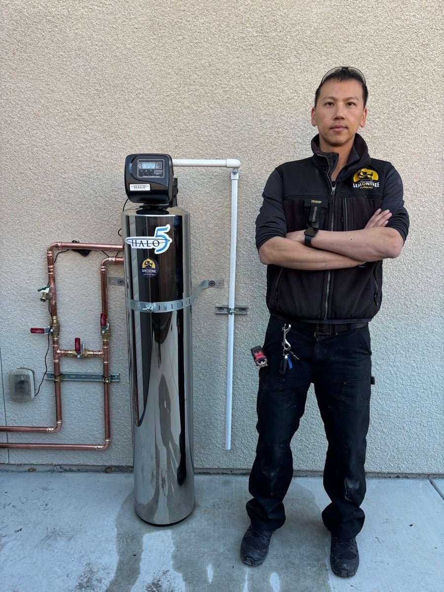 Technician with a newly installed whole-house water filtration system