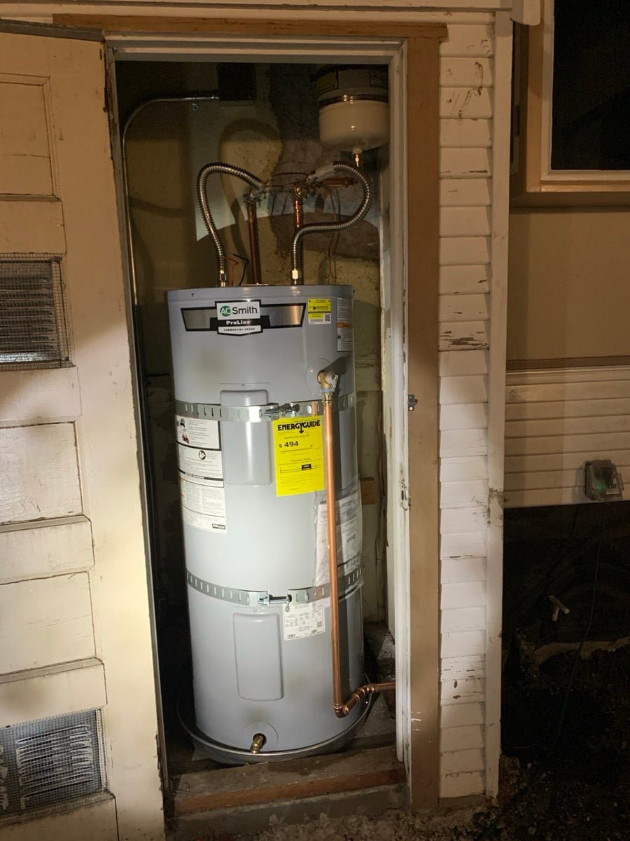 Tank water heater installed in an exterior closet