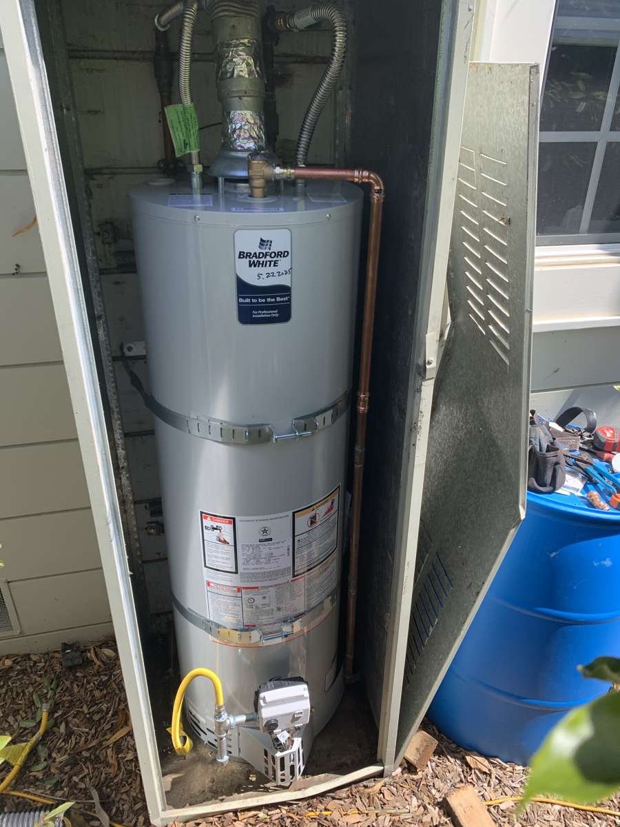 Tank water heater in an outdoor enclosure with new copper piping