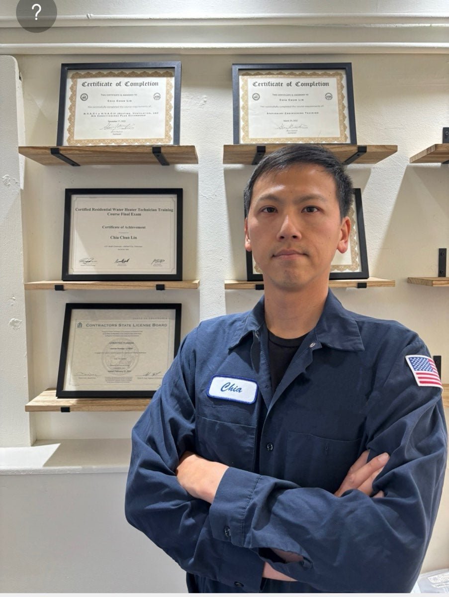 Technician portrait in front of certification wall