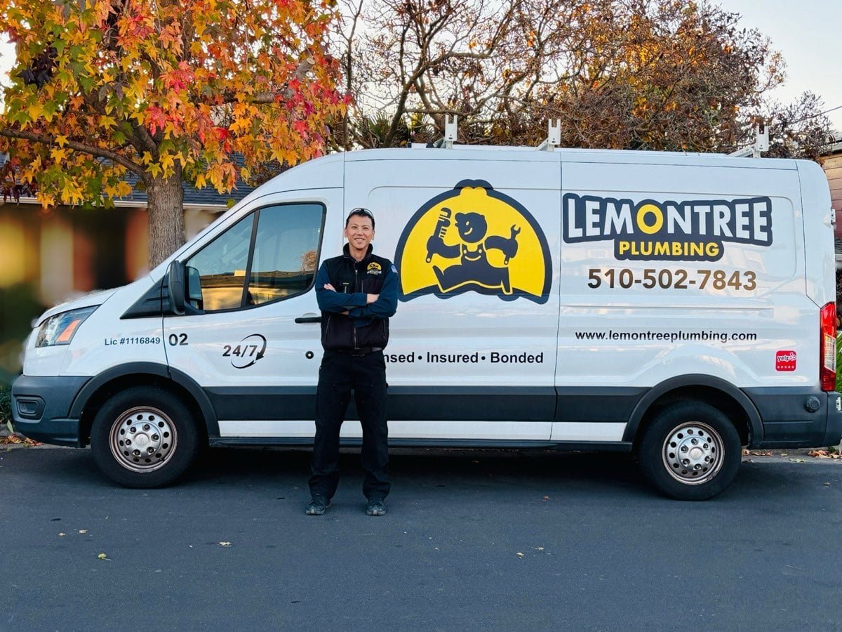 Technician standing in front of a branded company van