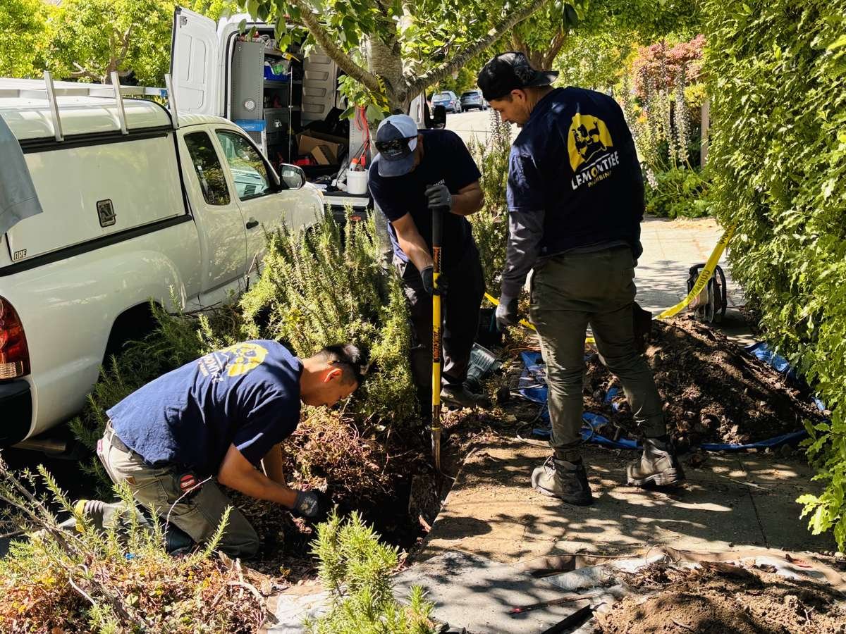 Hand-digging a sewer trench