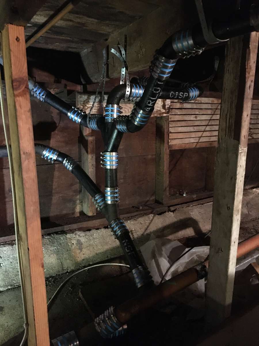 New drain piping installed between joists